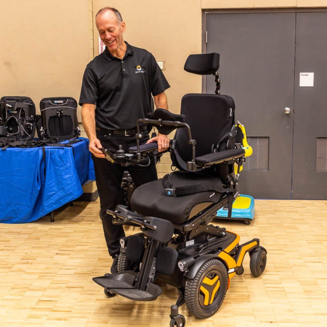 Motion employee with a power wheelchair at a trade show